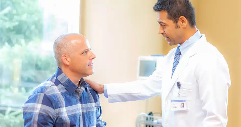 male doctor comforting male patient