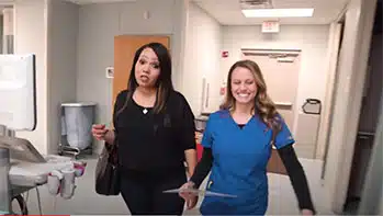 technologist walking with patient